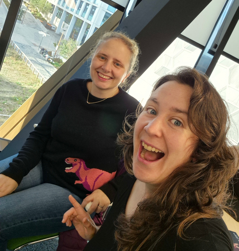 Claire and I smiling at the R-dev day. Claire is wearing an excellent dinosaur jumper.